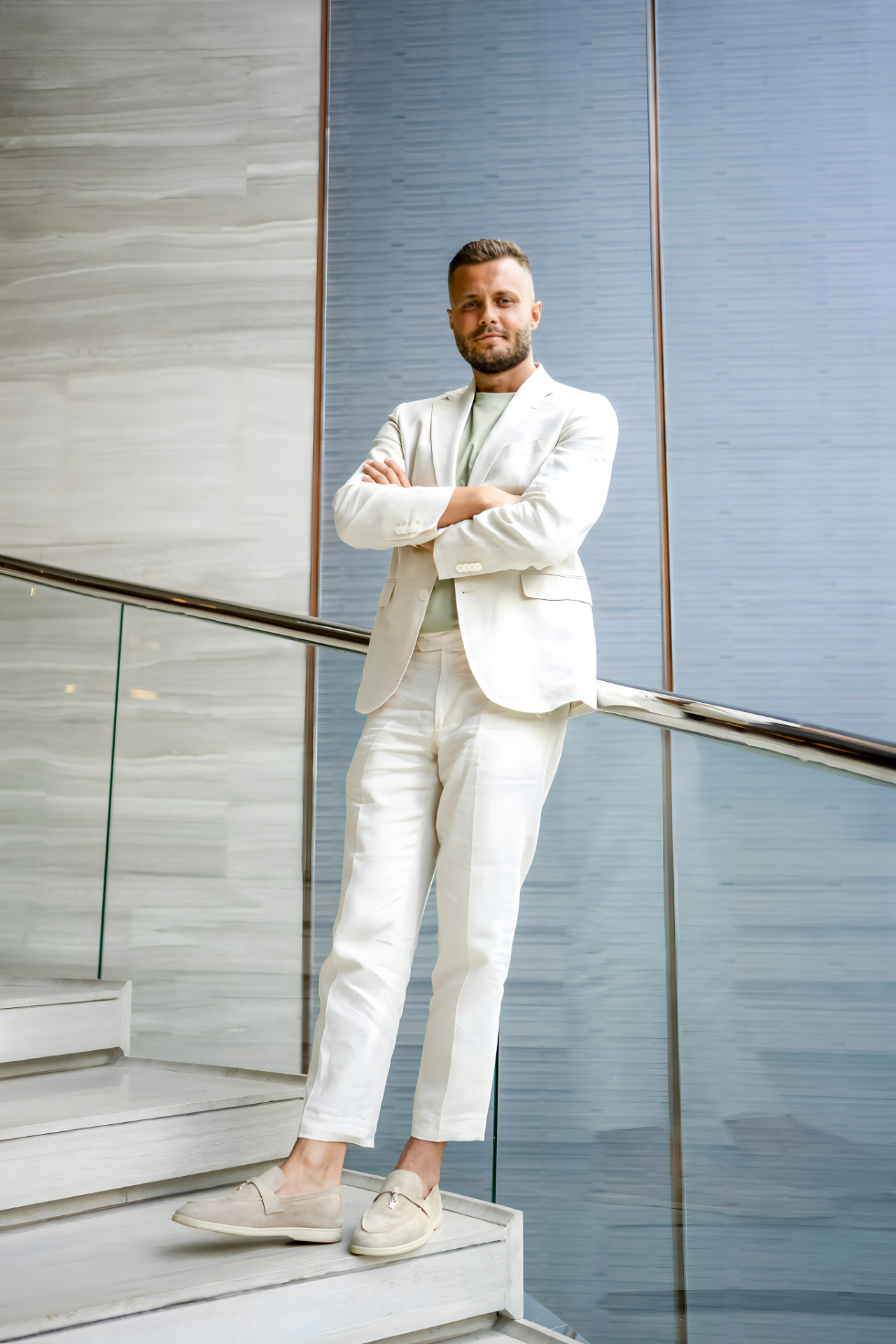 Zeljko Cikojevic standing on a modern staircase